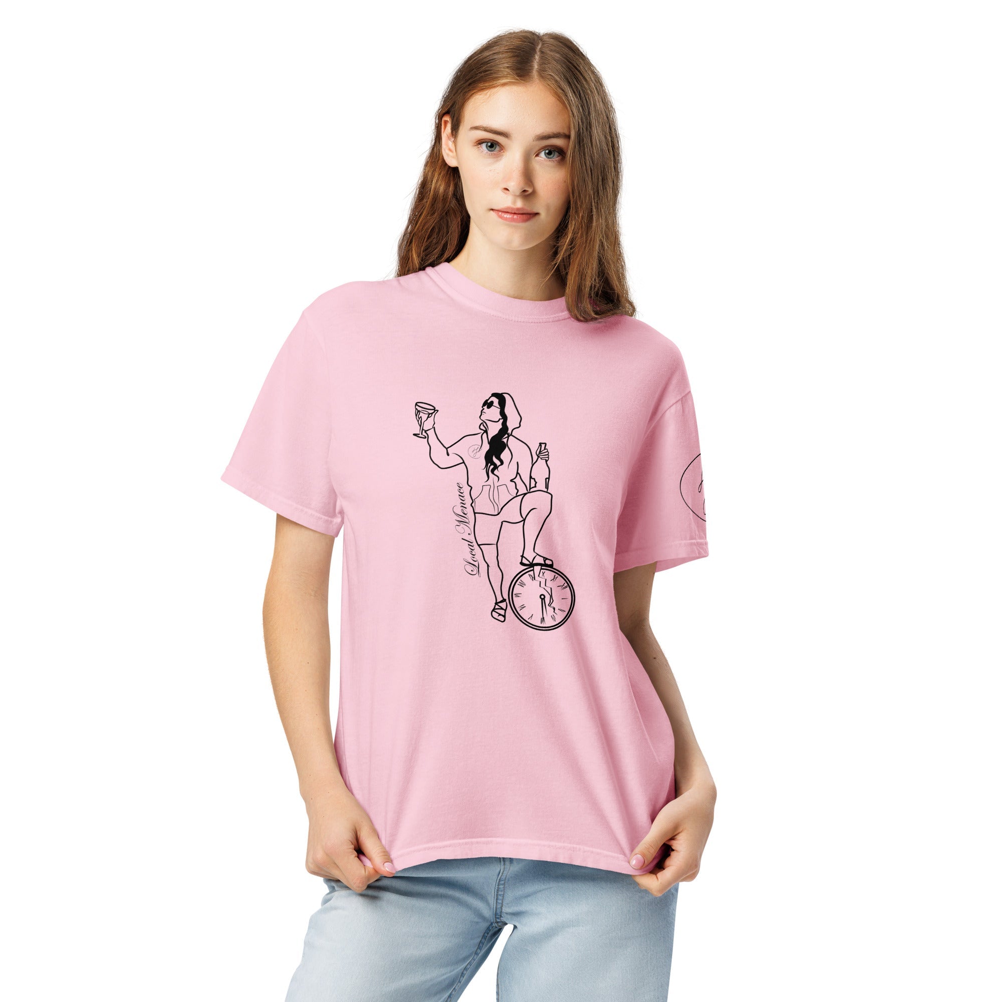 A pink graphic tee featuring a vintage-style line drawing of a woman in a hood and sunglasses. She is casually holding up a champagne glass while balancing on a broken clock face, embodying a deadpan, rebellious attitude.